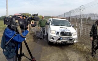 Filming a news report at the Hungarian border