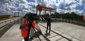 Filming piece to camera at a train terminal in Fenyeslitke