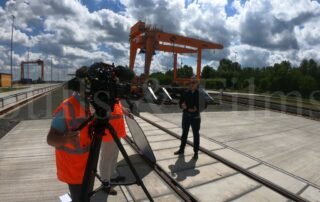 Filming piece to camera at a train terminal in Fenyeslitke